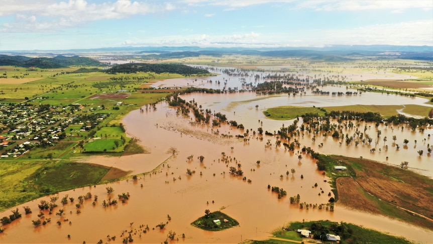 Brown floodwater spills out across plains.