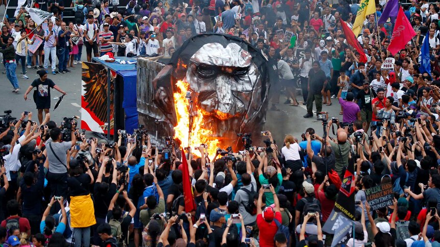 Protestors burn an effigy of Filipino president Rodrigo Duterte outside Congress