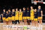 The Australian women's national basketball team stand arm in arm for the national anthem