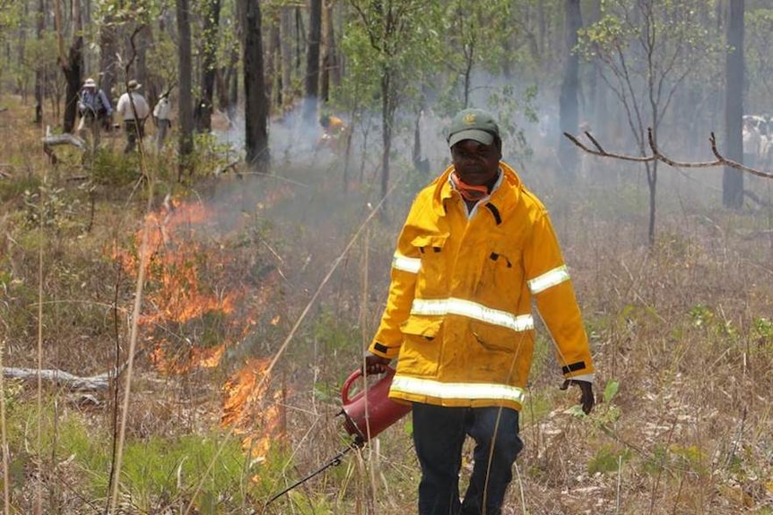 Indigenous Ranger Marcus Cameron conducting a controlled burn in Warddeken Indigenous Protected Area.
