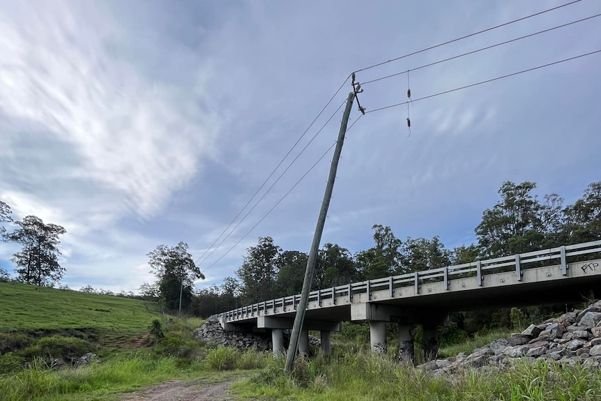 Poles leaning over a bridge at Beechmont after the storms.