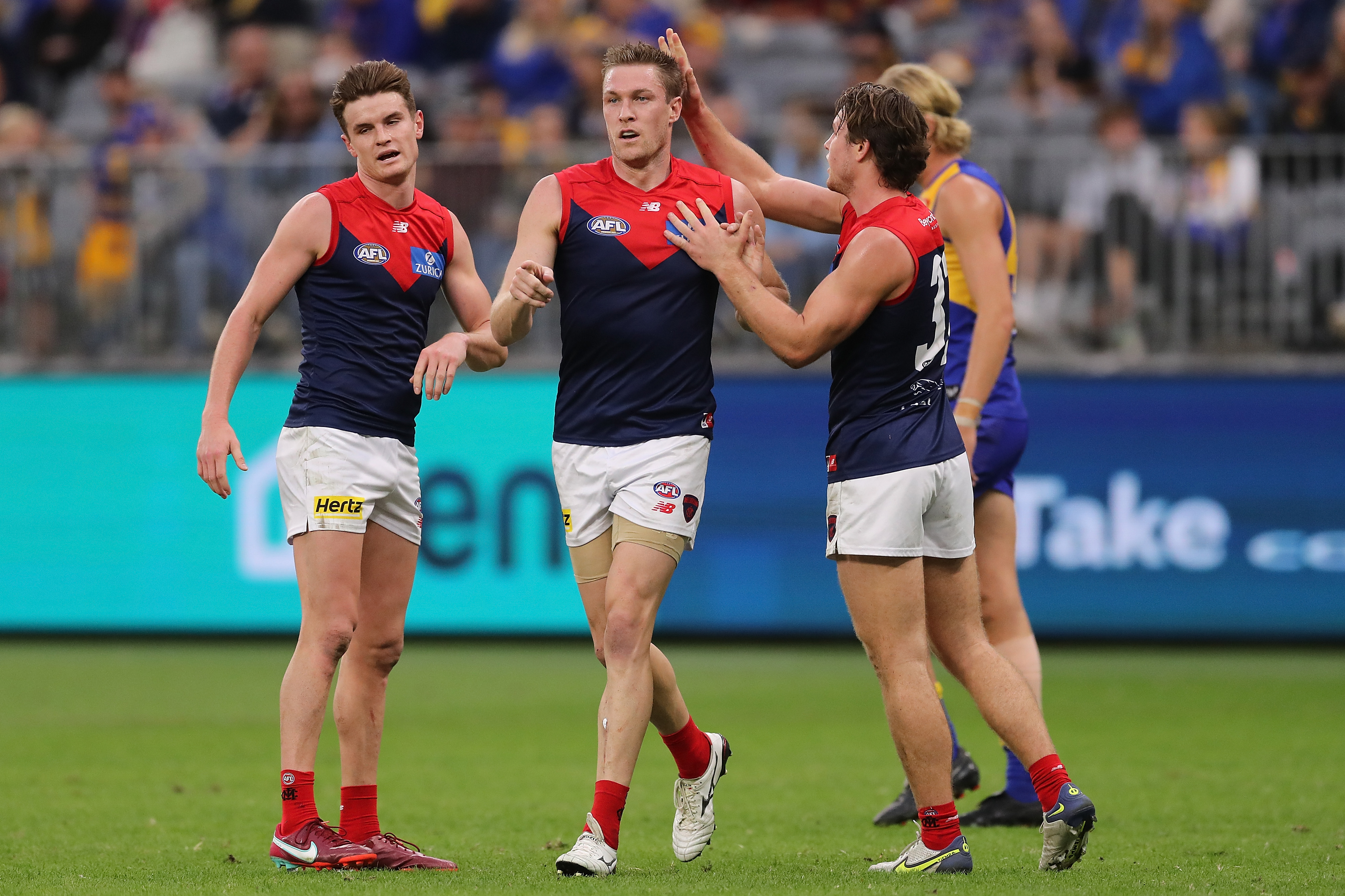 Tom McDonald is congratulated by Demons teammates
