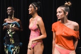 a group of young models wearing swimwear and dresses