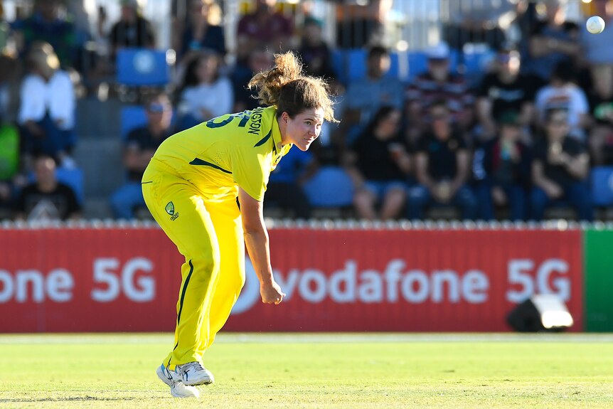 An Australia female bowler bowls a ball against India.