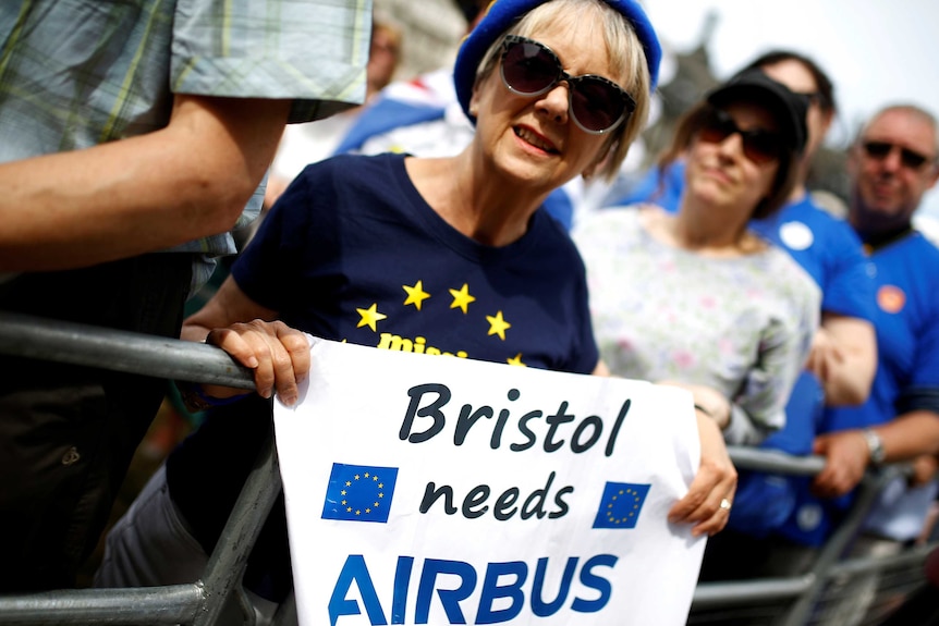 A woman holding a sign saying 'Bristol needs Airbus'