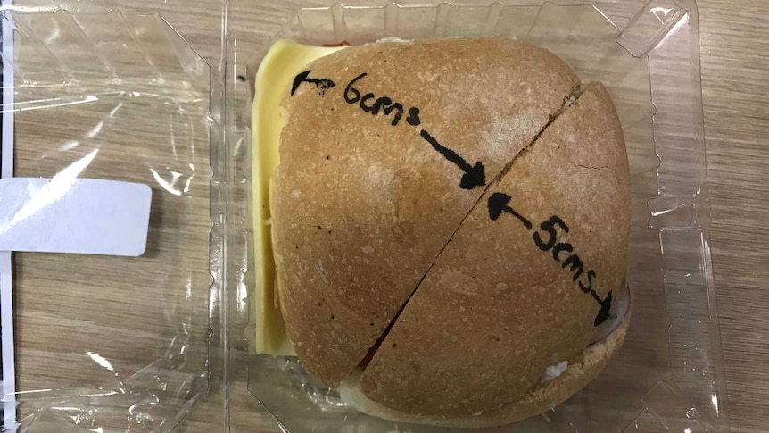 A bread roll cut diagonally with texta outlining the dimensions of each 'half'