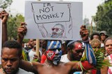 A Papuan student holds a poster saying 'I'm Not Monkey' during a protest in Jakarta.
