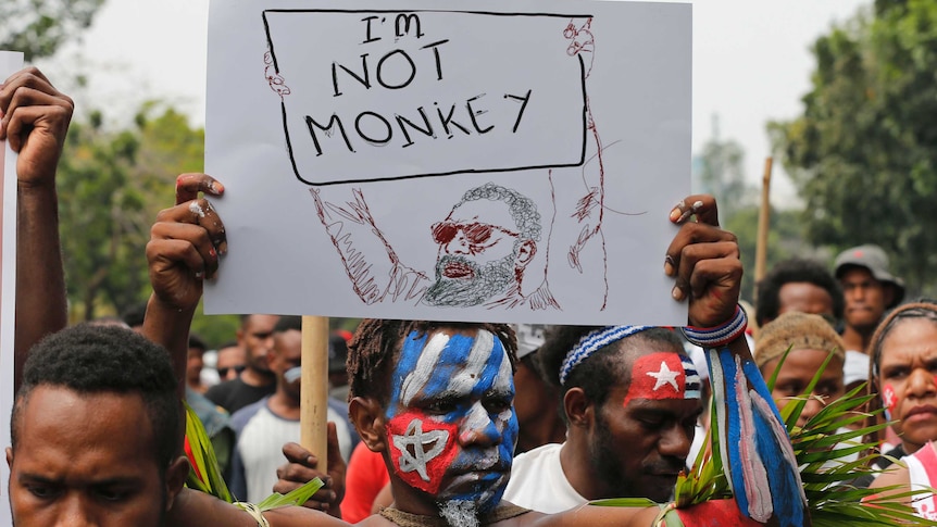 A Papuan student holds a poster saying 'I'm Not Monkey' during a protest in Jakarta.