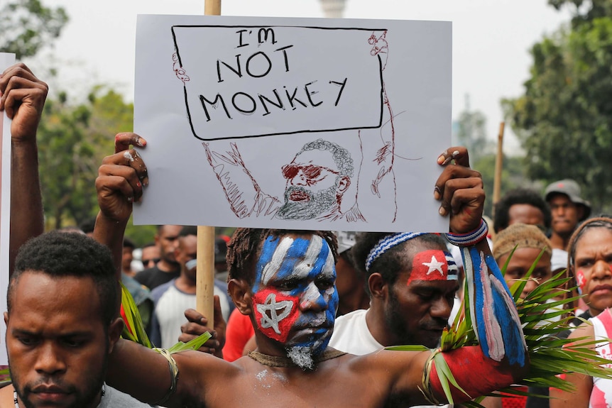A Papuan student holds a poster saying 'I'm Not Monkey' during a protest in Jakarta.