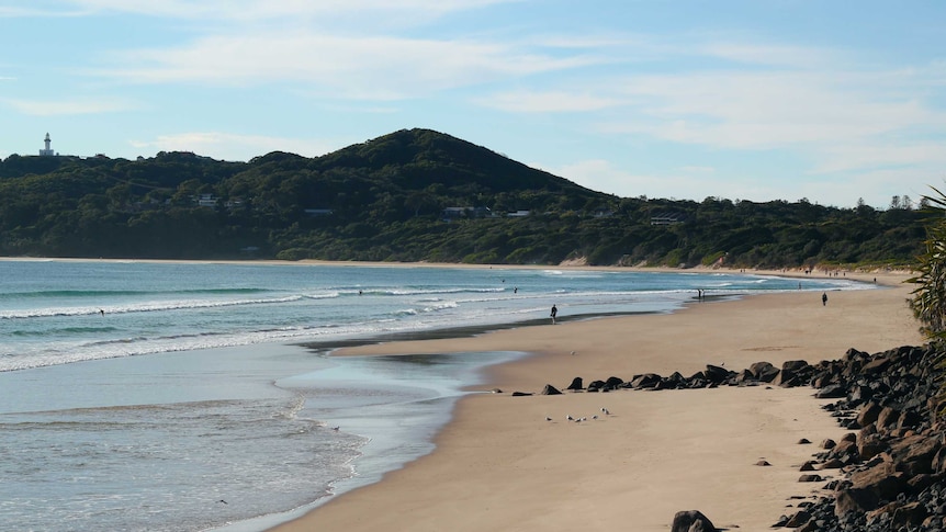 Picture of Byron Bay beach with famous lighthouse in the distance
