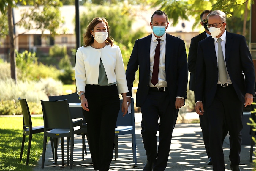 Anthony Albanese, Mark McGowan and Tania Lawrence walking in a row outside