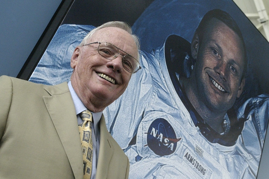 US astronaut Neil Armstrong poses in front of his photo during a visit to the Prince Felipe Museum.