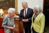 Queen on the left meets a husband an wife pair at Windsor Castle.