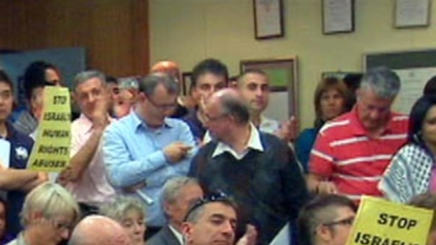 Pro-Palestinian and pro-Israeli supporters pack the public gallery