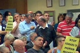 Pro-Palestinian and pro-Israeli supporters pack the public gallery