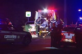 Police cars and ambulances at night