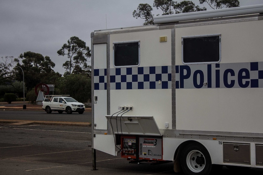 A police van parked on the side of the road.