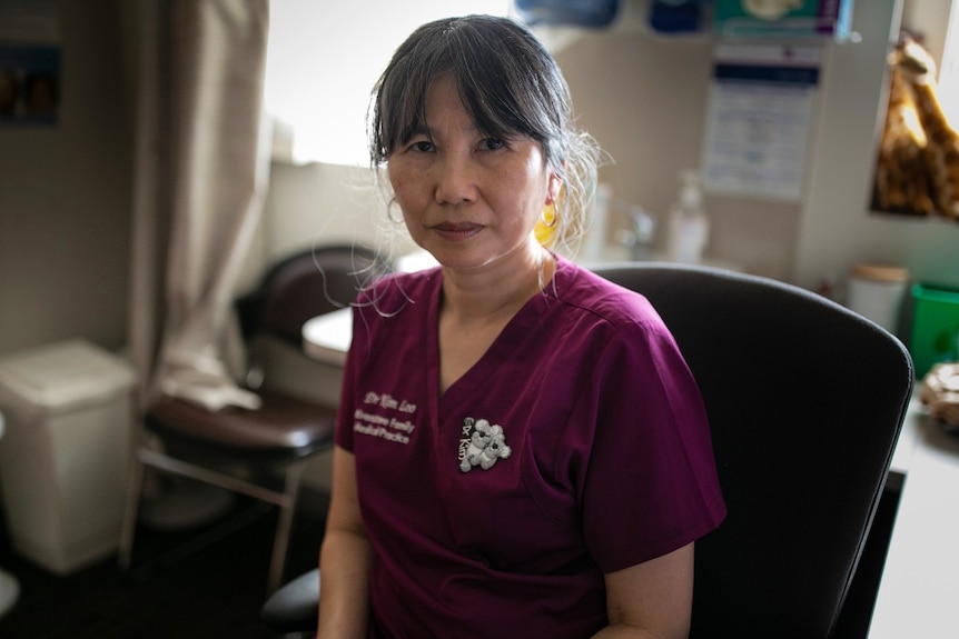 A woman in a purple shirt.