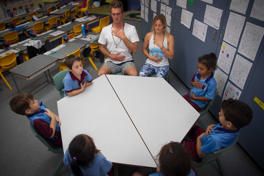 Primary school students learning breathing techniques with Bodhi Whitaker and Kat Tucker from The Breathe Project.