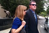 Watson leaves the Jefferson County courthouse in Birmingham, Alabama, with wife Kim Lewis.