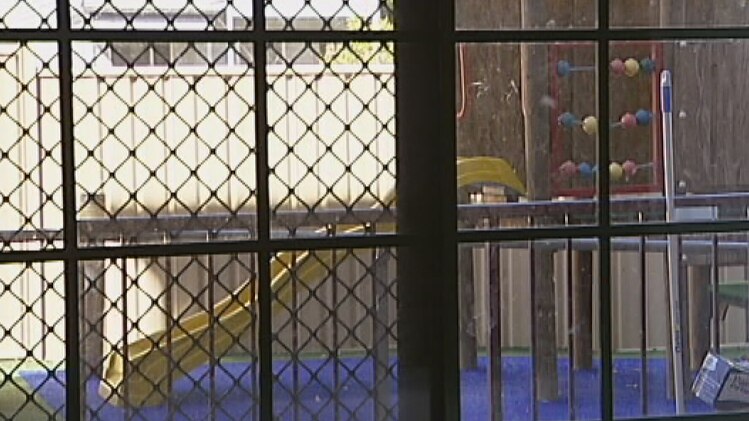 A playground viewed through a barred window.