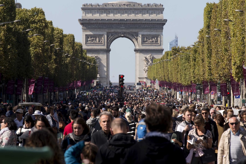 People walk on the Champs-Elysees as central Paris goes car-free.