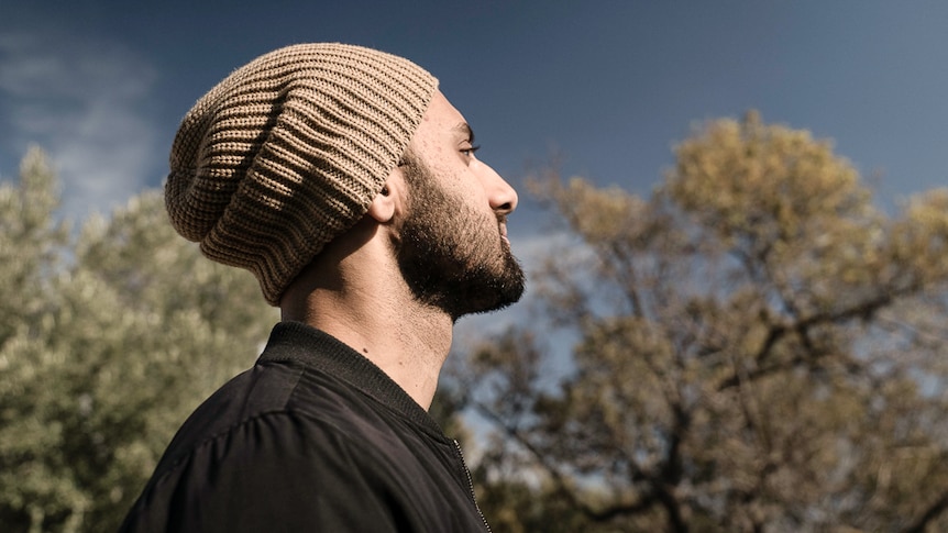 Head shot of Zohab Zee Khan looking at blue sky illustrating one of our 7 easy steps to start meditating.