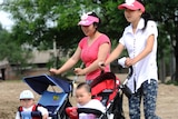 Women push children in prams in China
