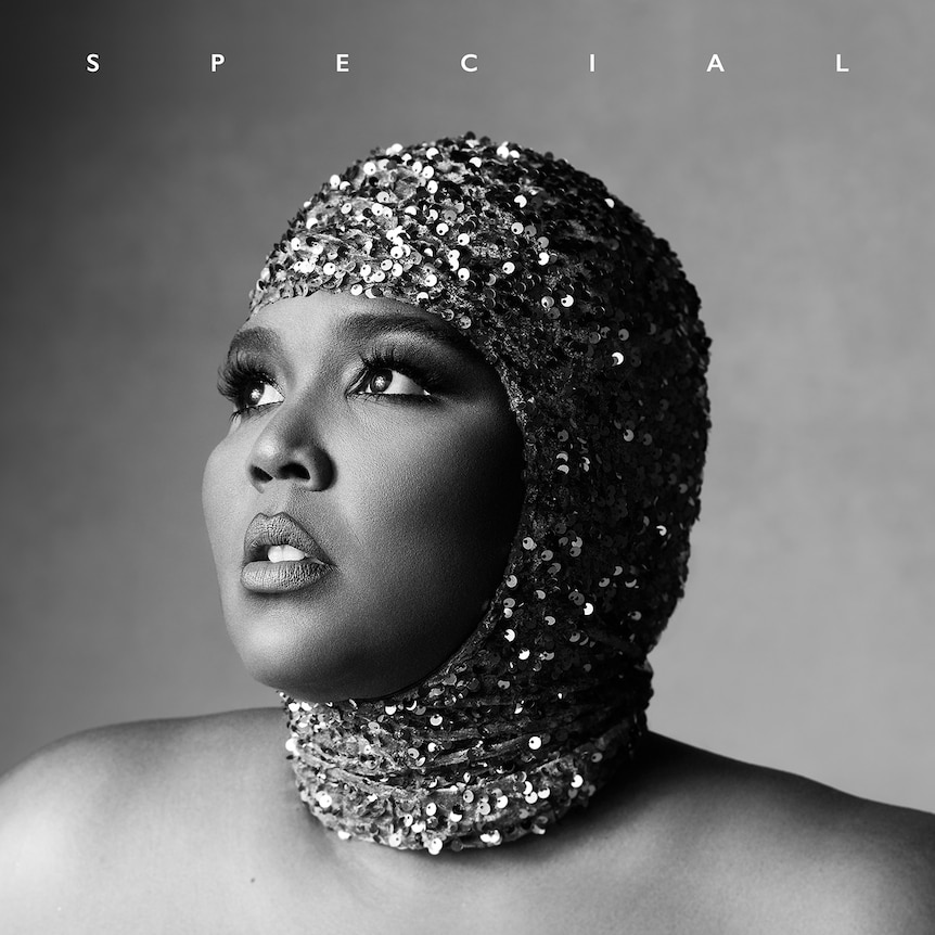 lizzo wears sequined headwear and stares away from camera