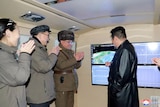 Military members applaude nation's leader in North Korea.
