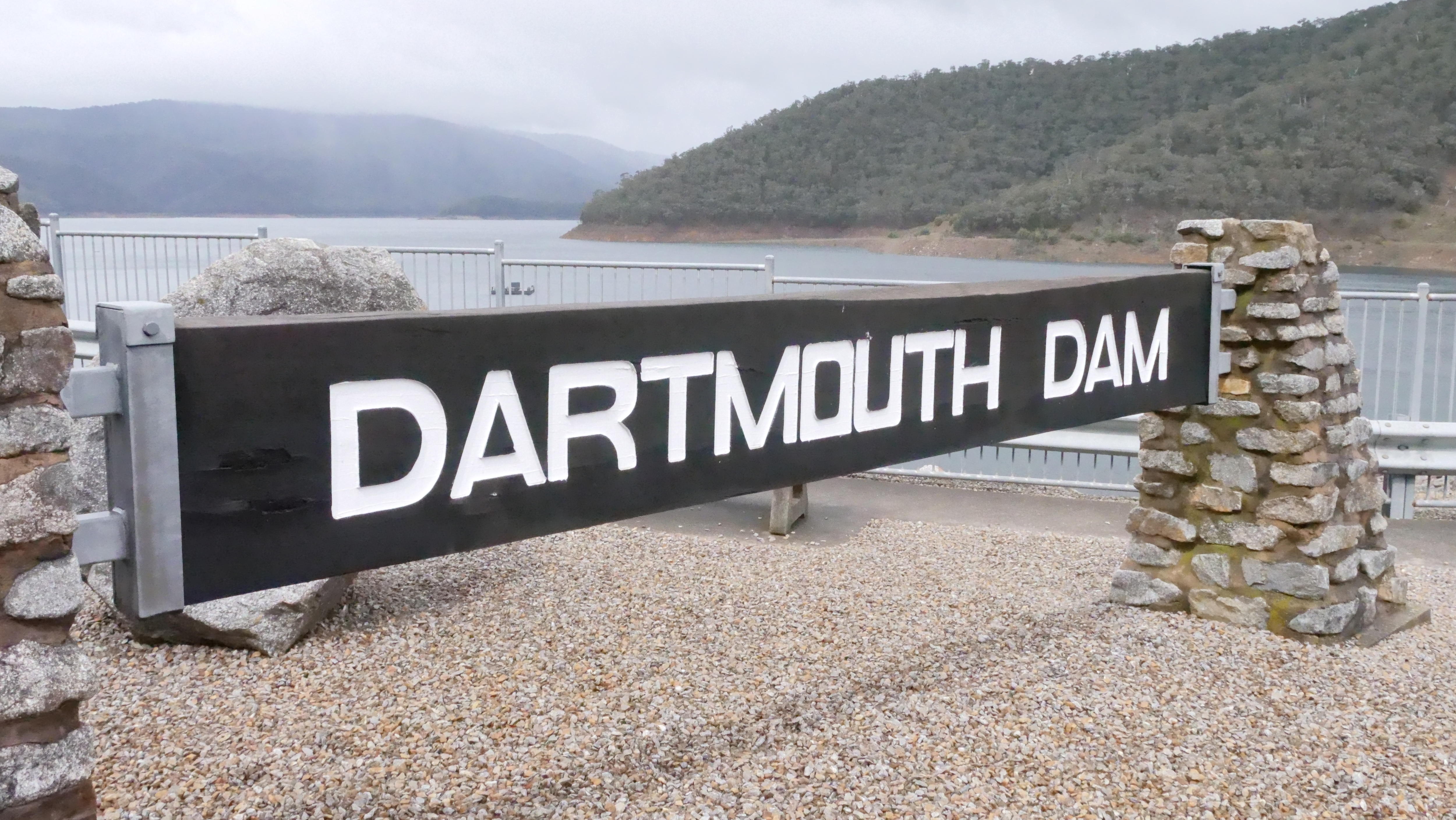 The view of Dartmouth Dam's signage over the water.