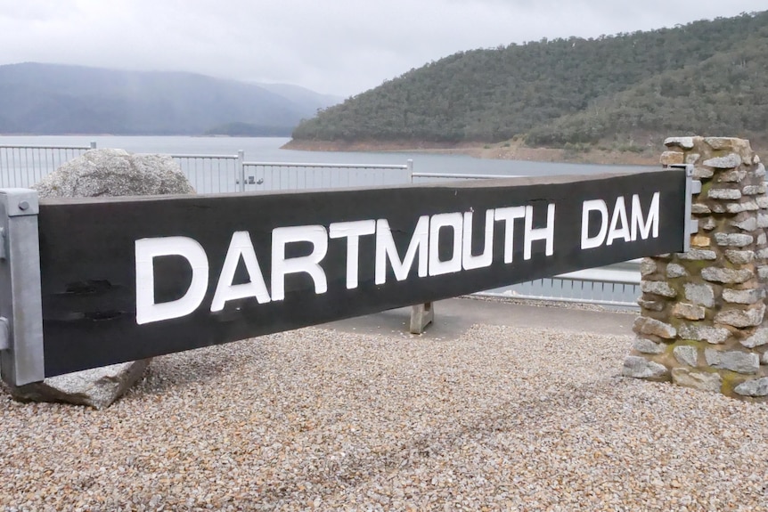 The view of Dartmouth Dam's signage over the water.
