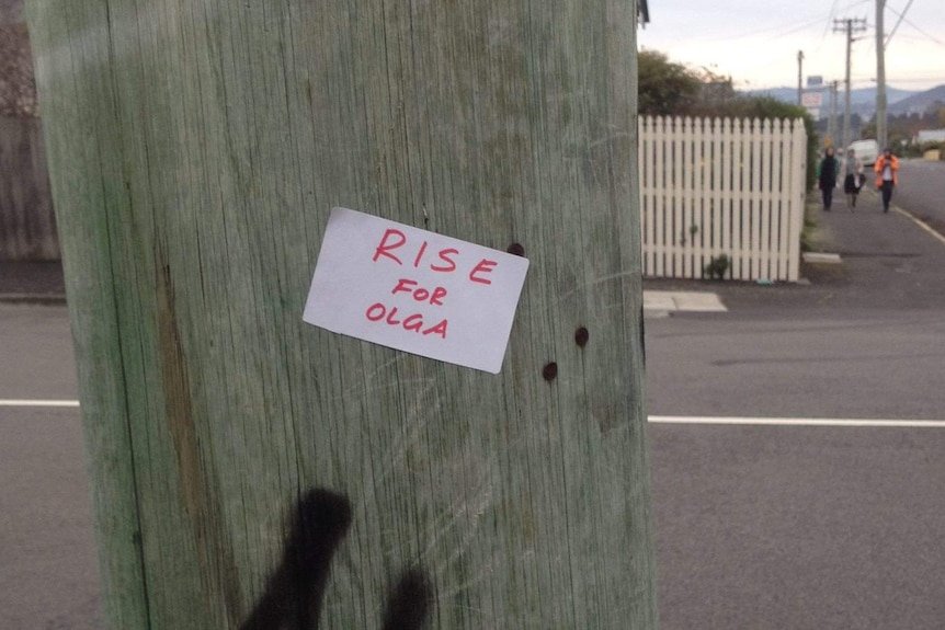 Stickers urge action on domestic violence after the killing of a Tasmanian woman shot on a busy Hobart road.