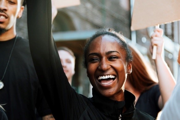 Young woman looking happy and engaged at a protest
