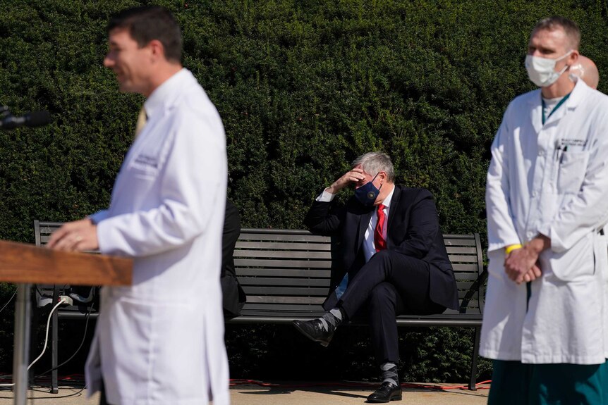 White House chief of staff Mark Meadows on the sideline of a medical press conference outdoors