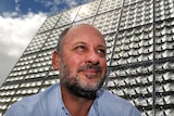Tim Flannery in front of solar array