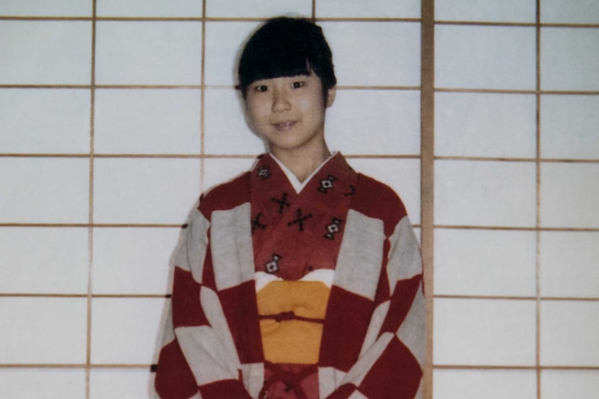 A Japanese teenaged girl in a red and white kimono