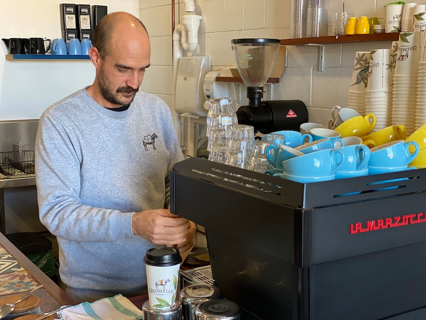 Man making coffee at machine