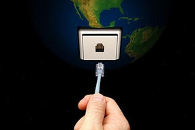 Hand Inserting a Plug into the Earth (Getty Creative Images: Chad Baker/Ryan McVay)