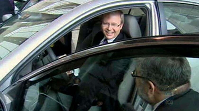 Prime Minister Kevin Rudd sits in a hybrid car while visiting Toyota in Nagoya, Japan