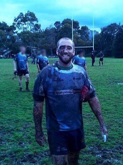 Michael John Quinn covered in mud after playing sports.