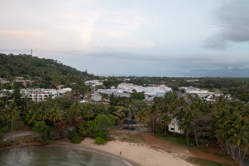 A town in the tropics on the edge of the ocean.