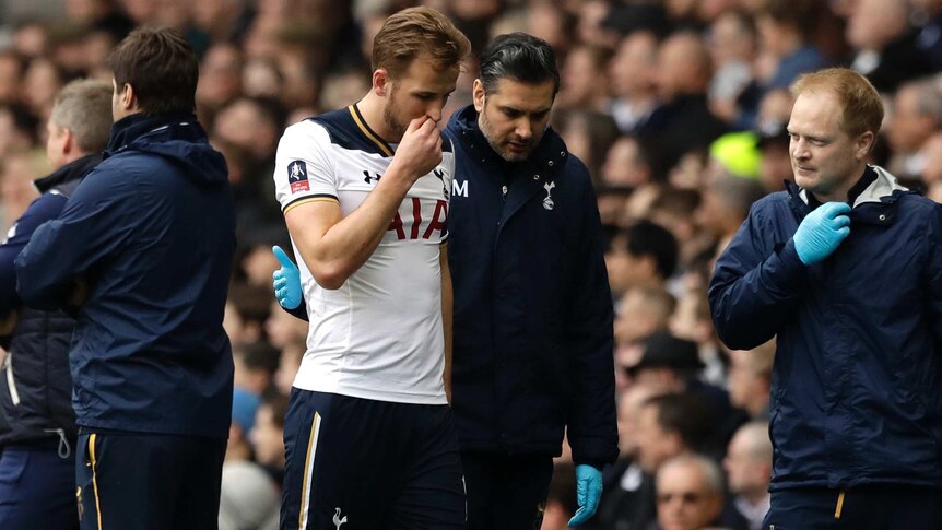 Spurs striker Harry Kane (centre left), leaves the pitch injured against Millwall in the FA Cup.