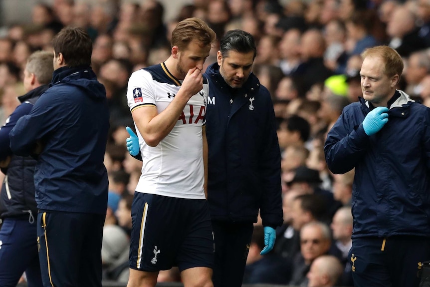 Spurs striker Harry Kane (centre left), leaves the pitch injured against Millwall in the FA Cup.