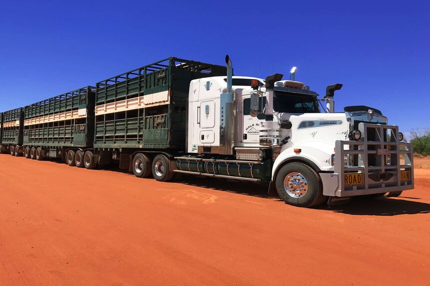 a road train on red dirt.