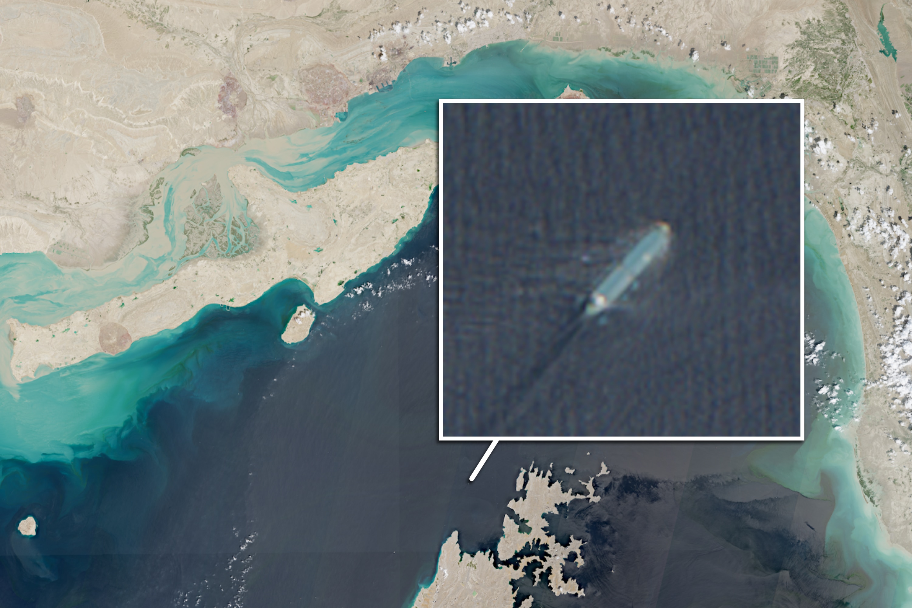 A satellite image of the Strait of Hormuz, and a inset zoomed in image of a large ship sailing in the ocean.