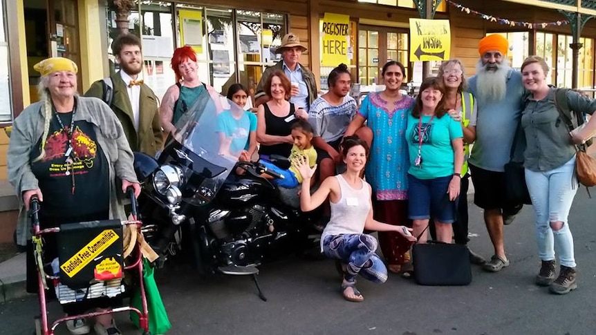 Group of people ranging in age from grandmother to child volunteering during the Lismore floods