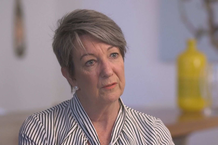 Pamela Robertson, wearing a striped shirt, tilts her head to the side.