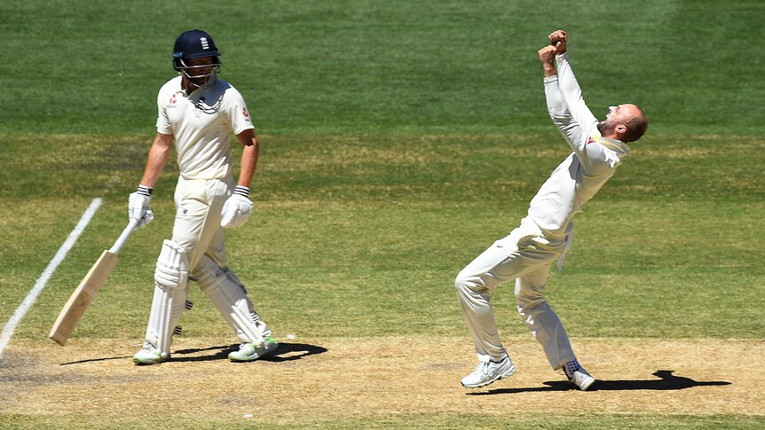 Nathan Lyon pumps his fists after dismissing Moeen Ali, as Jonny Bairstow looks on.