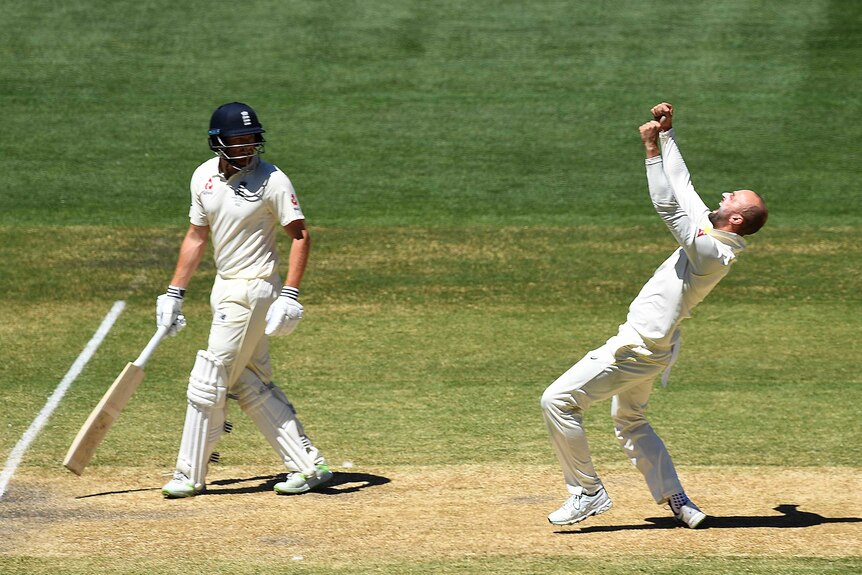 Nathan Lyon pumps his fists after dismissing Moeen Ali, as Jonny Bairstow looks on.